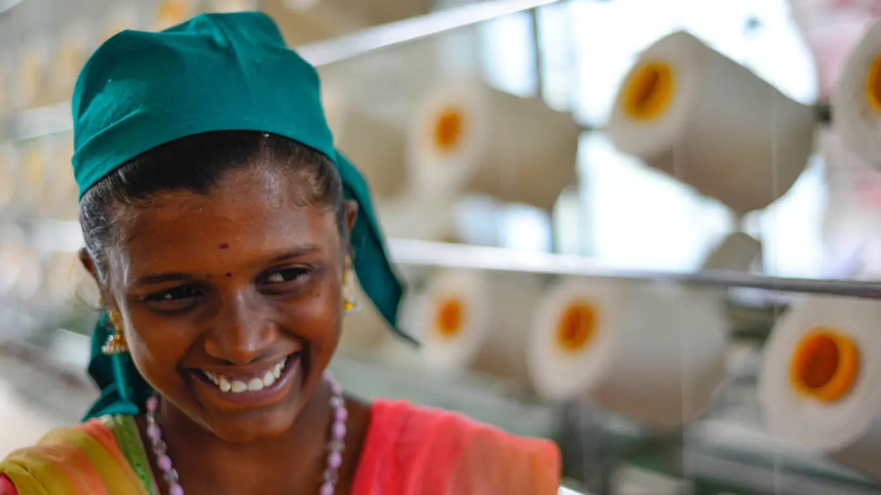 Close up of female smiling with thread behind her