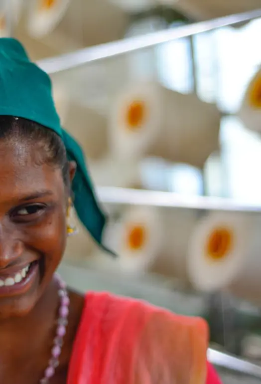 Close up of female smiling with thread behind her