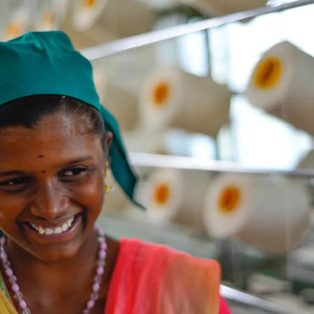Close up of female smiling with thread behind her