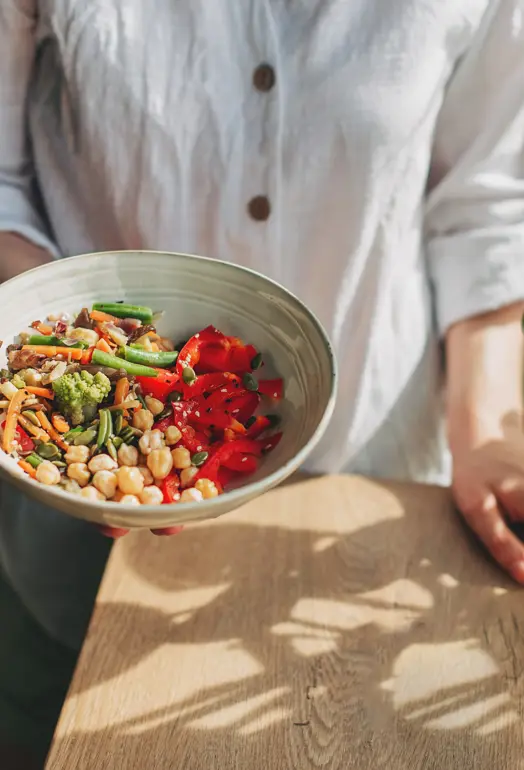 person holding a bowl of healthy food