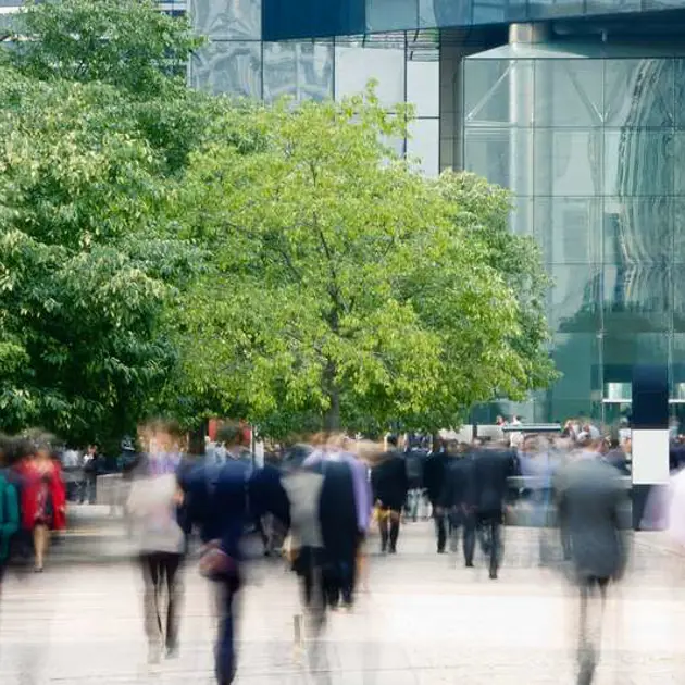 people commuting with green areas around them