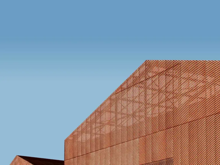 blue sky with a metal building in the foreground