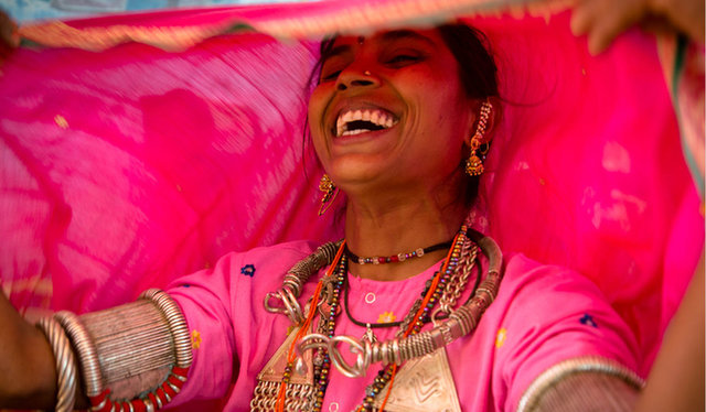 woman wearing pink clothing and laughing