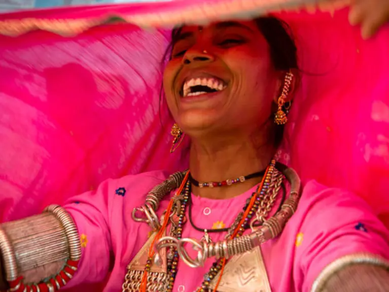 woman wearing pink clothing and laughing