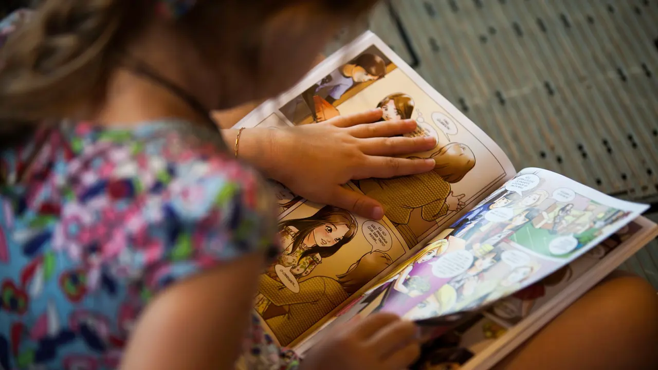 A view over the shoulder of someone reading a comic book