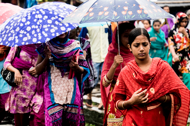 A street of people walking with umbrellas