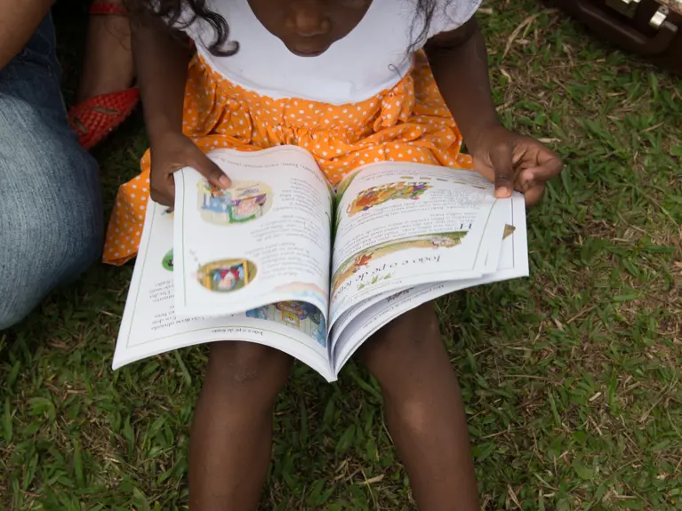 small child reading a book