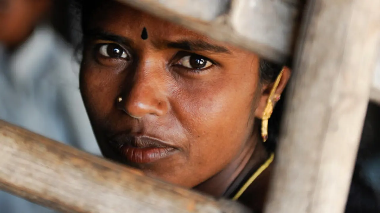 A close up of a woman's face with emotive eyes